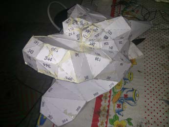 A folded paper wing section during template construction.