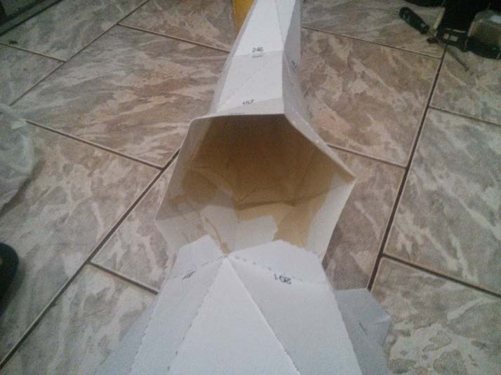 Flat Pepakura shell sections laid out on the floor before assembly.