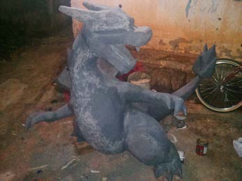 The primed grey body and tail standing outdoors before colour.