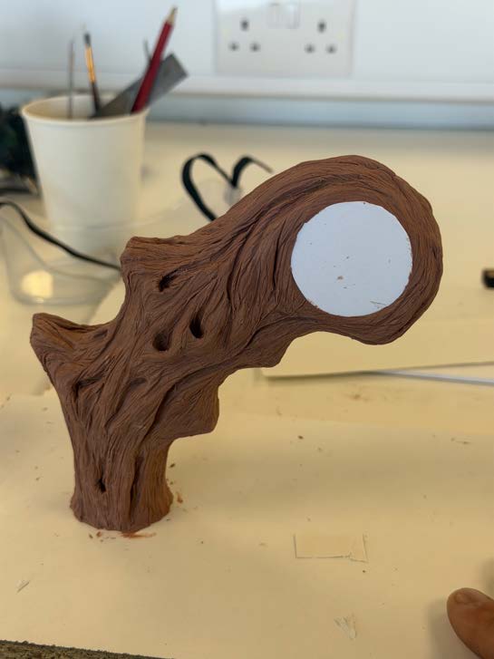 A 3D-printed decorative handle component on the workbench prior to finishing.
