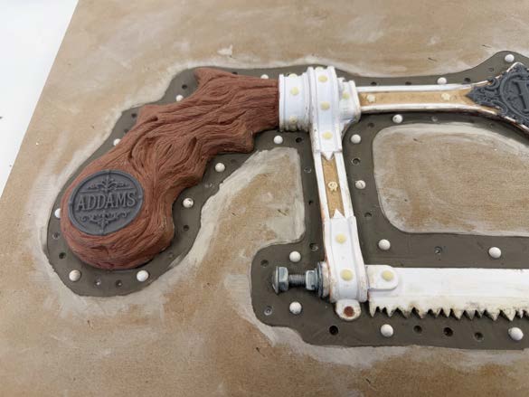 The assembled bone saw before final weathering, showing raw cast and printed parts.