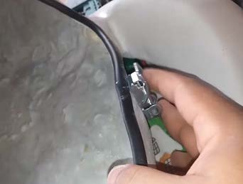 A hand fitting the drainage outlet and tap into the base of the cooler.