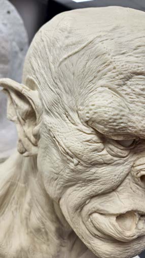 Close-up of the clay sculpt with fine wrinkle and pore texture worked into the surface.