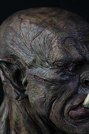 Macro detail of the painted skin surface showing pores, wrinkles and layered washes.