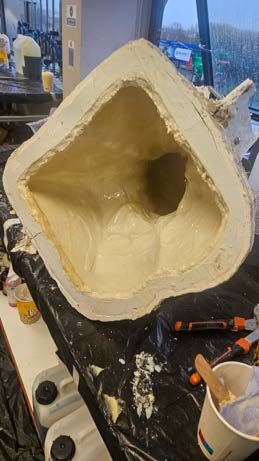The opened mould of the bust showing the cast interior after demoulding.