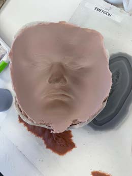 A cast prosthetic appliance released from the mould, showing thin blending edges.
