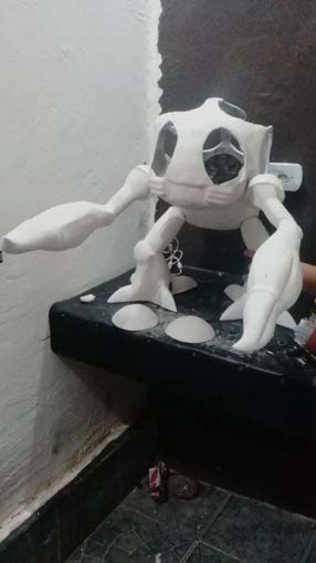 The primed white shell assembled on its base ahead of painting.