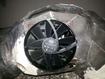 Close-up of the exhaust fan aperture cut and reinforced in the shell.