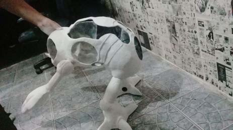 A hand smoothing filler over the fibreglassed shell during surface preparation.