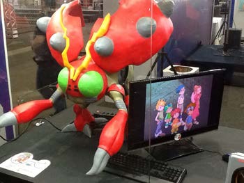 The character build powered on beside a monitor, acting as a working computer case.